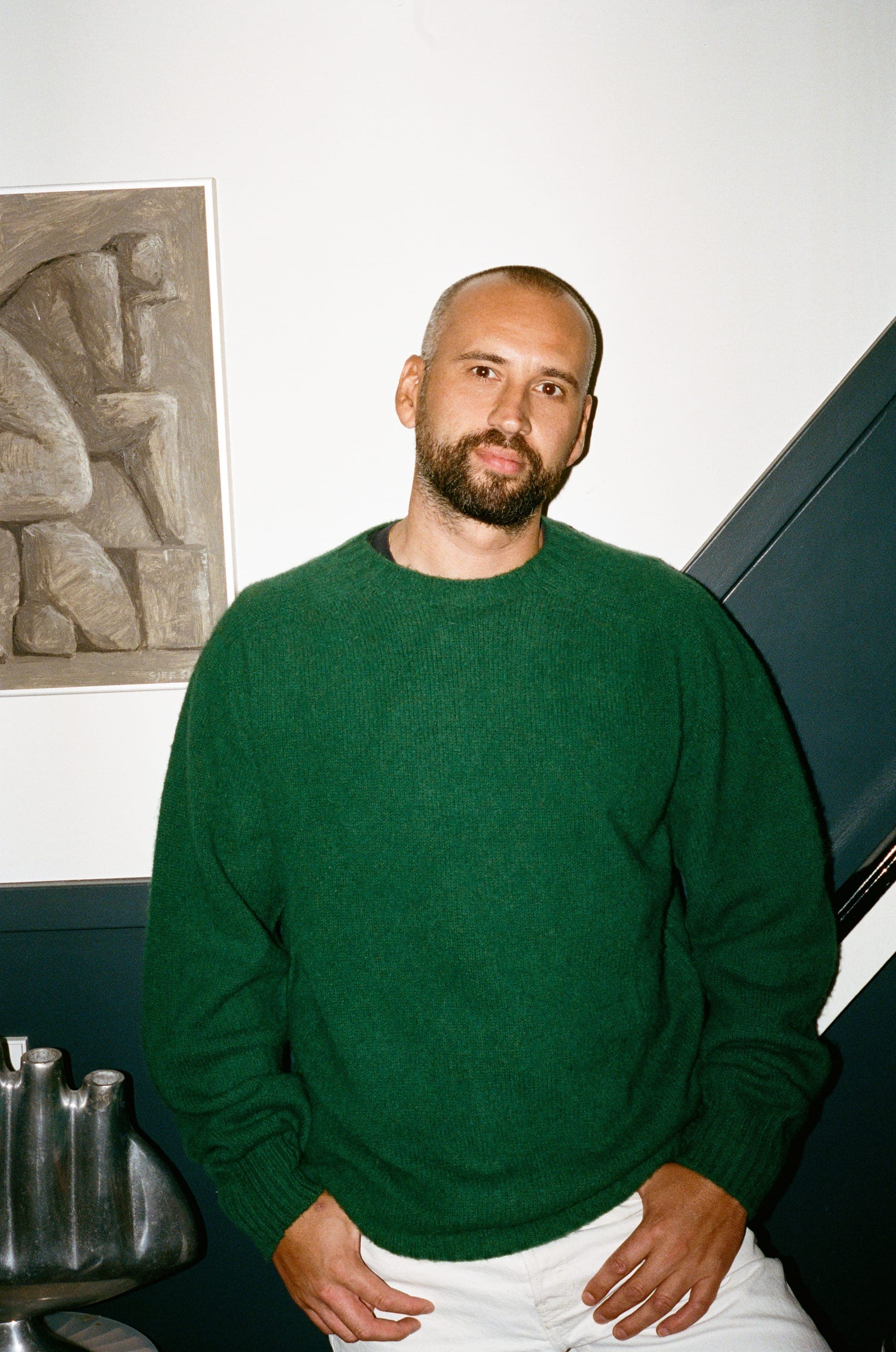 Vasco de Vries at home, wearing a green Le Bonnet crewneck